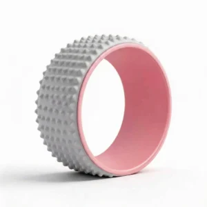 Grey yoga wheel with textured massage surface for deep tissue back stretching and spine alignment.