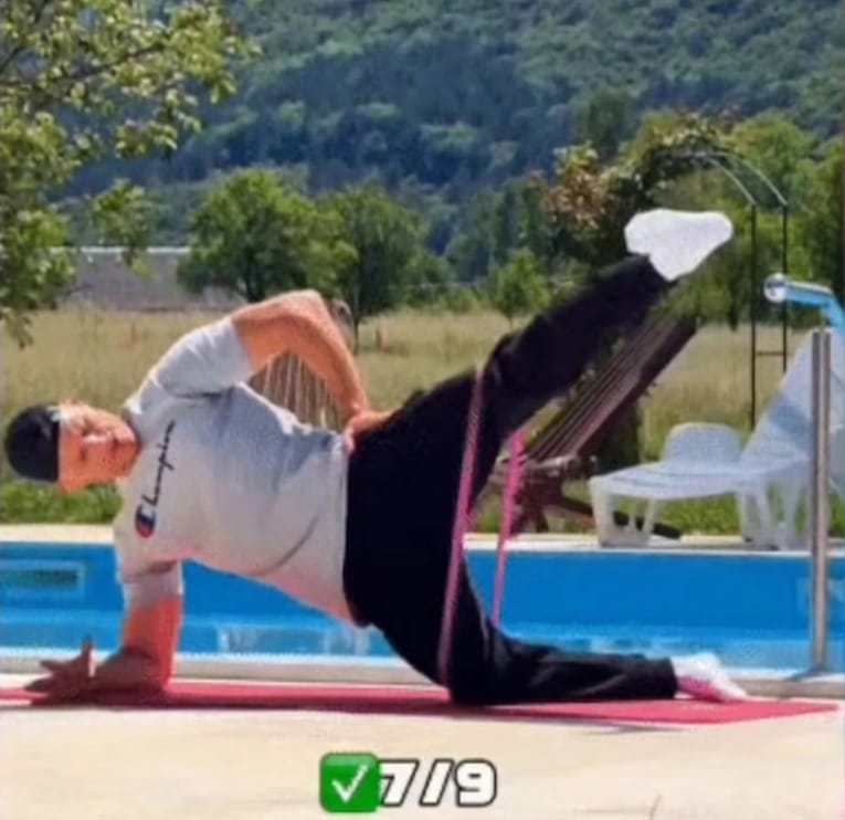 The Sedentary Desk Worker’s Survival Guide: 9 Home Rehab Exercises to Eliminate Lower Back Pain, Anterior Pelvic Tilt, and "Tech Neck" 12 A trainer performing a banded side plank leg raise with a pink resistance band to stabilize the pelvis and reduce lower back pain from sitting