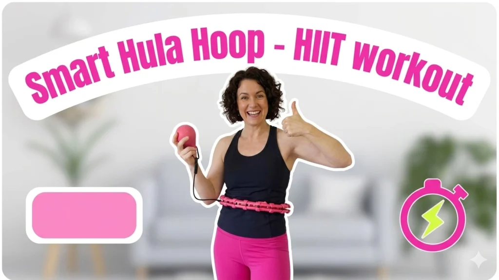 smart hula hoop vs. Traditional Hula Hoops: The Ultimate 2026 Comparison (No Bruises, No Drops!) 6 Smart Hula Hoop - HIIT workout, showing a smiling woman giving a thumbs up while exercising with a pink smart weighted hoop in her living room.