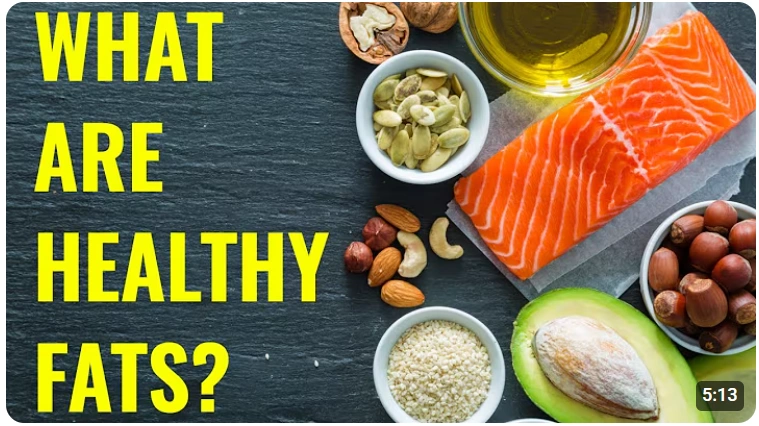 A variety of healthy fats including salmon, avocado, and nuts on a dark background.
