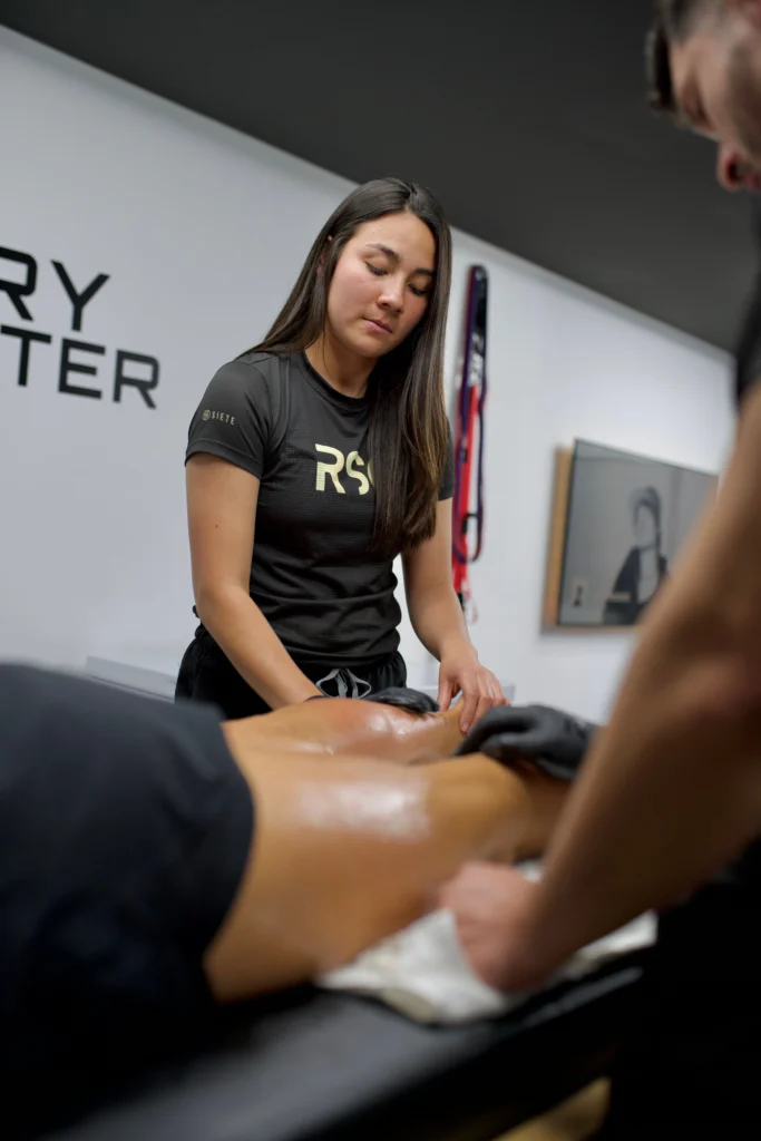 Woman receiving professional muscle recovery and leg massage for fitness for women over 35